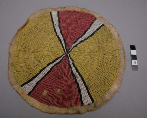 Circular tipi ornament--red yellow, black, and white beadwork on skin