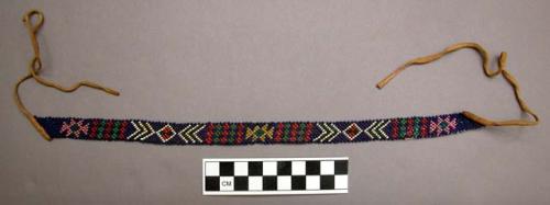 Small neck band of beadwork - colored beads on dark blue background; leather str