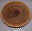 Basketry plate, coiled weave, natural color, lugali
