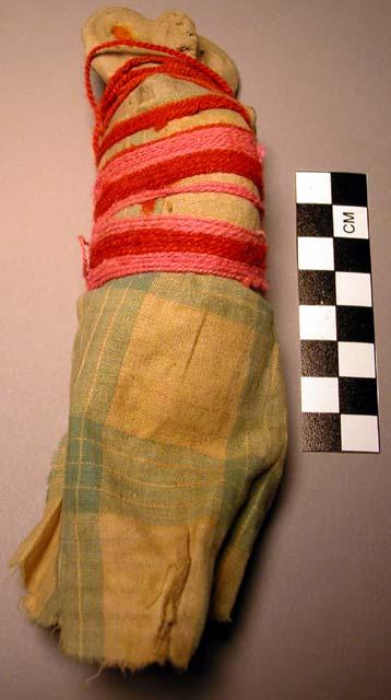 Child's doll - clay wrapped with cloth and pink and red string, pregnant female