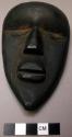 Small wooden mask.  "Yumbo si Gli."