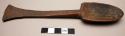 Spoon; carved wood; flat flared handle; traces of black pigment; worn