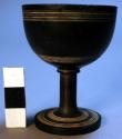 Small wooden cup on stand