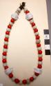 Necklace, alternating red & white round glass beads on veg. fiber cord