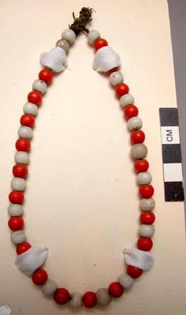 Necklace, alternating red & white round glass beads on veg. fiber cord