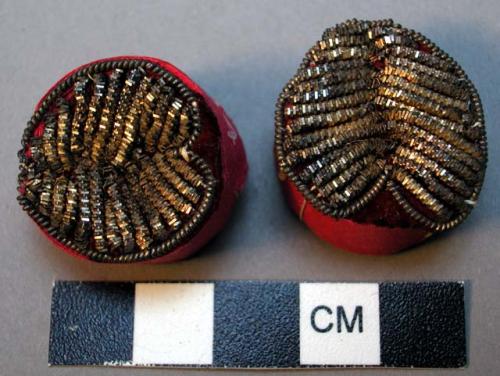 Ear plugs; rolled pink paper; metal decoration sewn to pink cloth