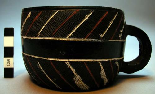 Cup, ceramic, black slip, incised, red & white painted stripes, loop handle