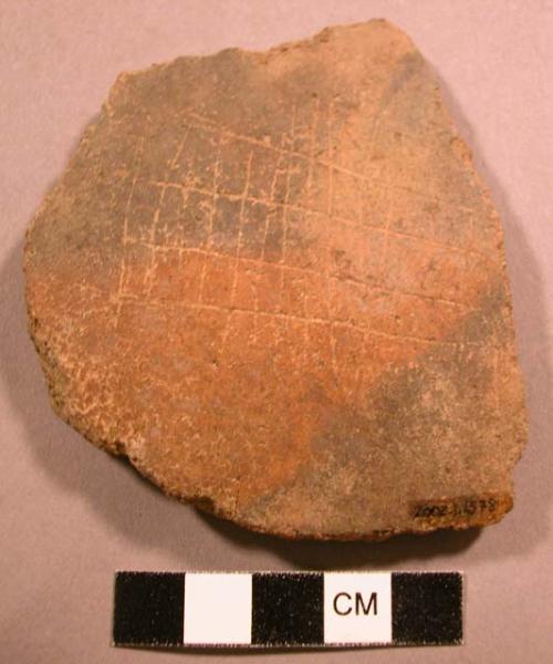 Ceramic sherd, reddish brown, fireclouded, incised rectangular design