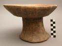 Stool; carved wood; fluted pedestal base; seat concave seat; abraided
