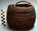 Small basket made of vine filler rings and woven with palmetto