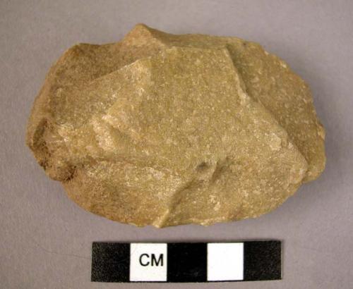 Small ovate quartzite hand axe, wavy edge; roughly flaked by "step" technique