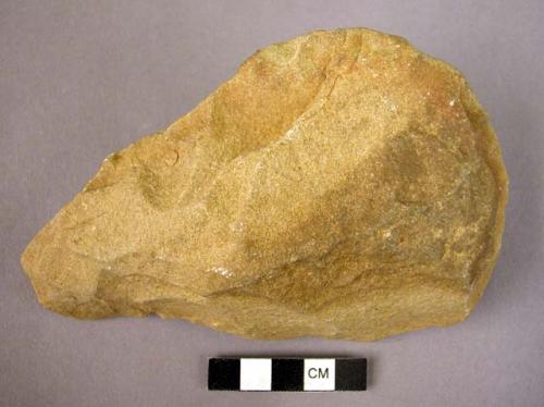 Crude quartzite hand axe, chipped all around circumference, slightly rolled