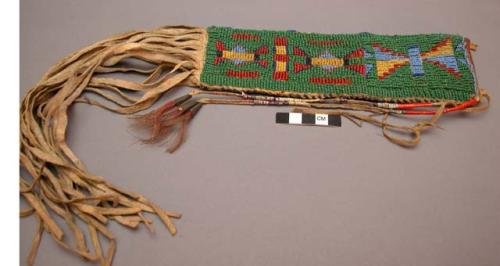 Beaded skin pouch with fringe