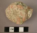 Pot fragment?; stamp fragment?.