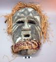 Carved wood mask with grey and black painted decorations; raffia and woven fiber