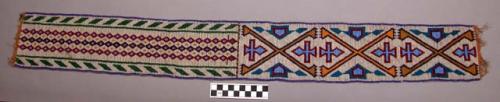 Bead work: white beads with design. Probably decoration for a bag