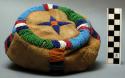 Circular skin pouch with drawstring and loop handle; beadwork design
