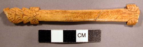 1 long flat piece of bone with incised decoration