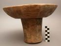 Stool; carved wood; cylindrical base; circular concave seat; geom. designs ext.