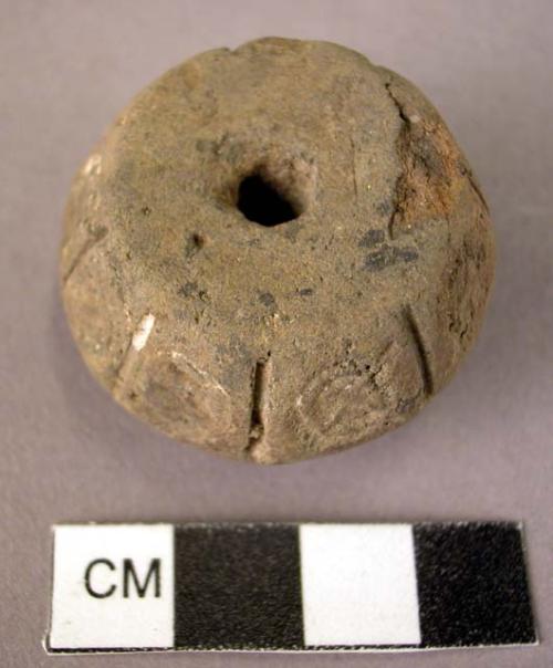 Pottery spindle whorl with incised and colored designs