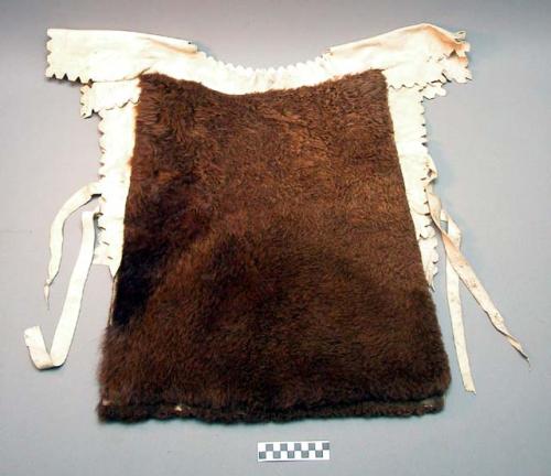 Short 'poncho' of buffalo skin. Neck piece edged with buckskin.