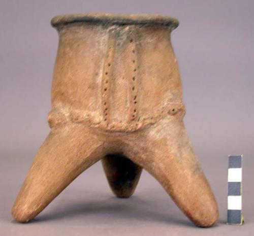 Unpainted pottery tripod jar with relief, incision, punctation