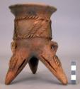 Unpainted pottery tripod jar - feet are rattles, relief and incised decoration