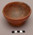 Clay bowl, possibly from the Plains. Small base molded to sit upright. Red ware.