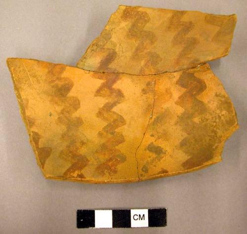 Ceramic rim sherd, bowl, red on orange zig-zag decoration