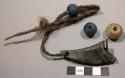 Pendant (?); perf. horn attached to braded veg. fiber cord; w/blue & white glass