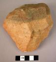 Coarse, heavily rolled quartzite flake implement