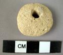 1 perfoated pottery disc --  a spindle whorl?