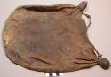 Skin carrying bag, not dyed, sewn seams, and two tufts, tie is made of sinew. ca