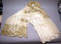 Woman's beige gauze blouse with floral gold embroidery around the collar and sle