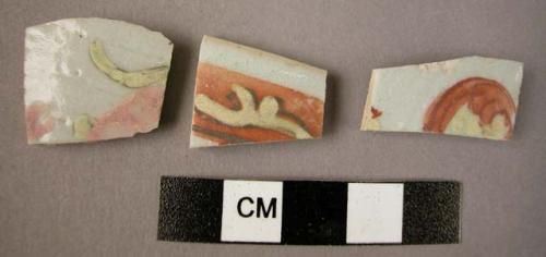 Ceramic sherds, fine ware, blue glazed with red and green painted floral design