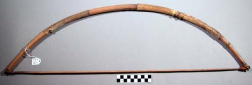 Wooden bow, fibre bow string, pieces of antelope skin wrapped around (tiba)