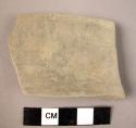 Grey rim sherd, fine paste, ext. orig. burnished, traces remain, int. too weathe