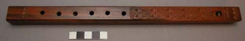 Wooden flute with carved design. length 12".