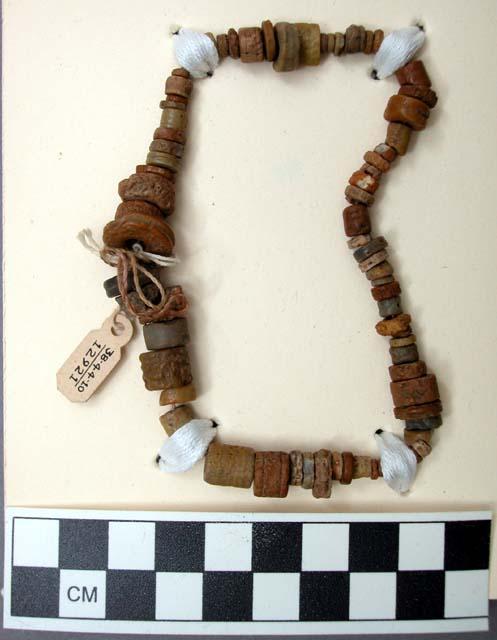 String of prehistoric beads made from different sizes of fossilized crinoid stem