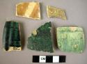 Potsherds (5); glazed; 4 greenish, 1 brown and buff, 1 with excised exterior.