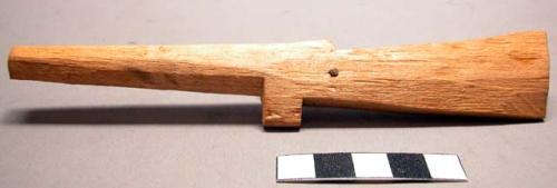 Sculpture, wood carved object, notched, in shape of gun, metal nail