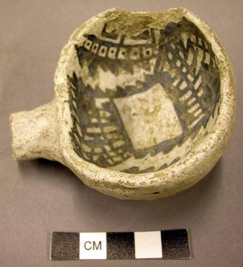 Part of black-on-white pottery ladle