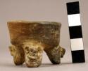 Miniature reddish buff pottery tripod vessel - animal head legs