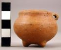 Miniature red pottery vessel - tripod handle