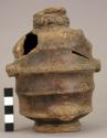Ring-base Black Monochrome pitcher with female effigy on top tier; 2 anthropomor