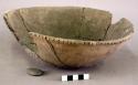 Ceramic bowl, incised rim, shell temper, mended, pebble inside.