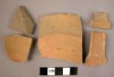 Ceramic body and handle sherds, red wheelmade ware, worn black slip