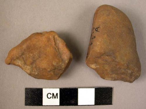 2 heavily rolled quartzite pebble implements, human?