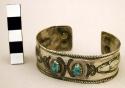 Silver bracelet with stamped designs and turquoise inlay