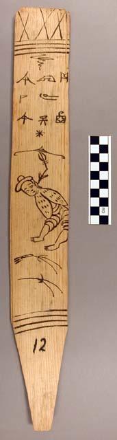 Ornament?, flat stick, black painted designs - human with spots on clothing